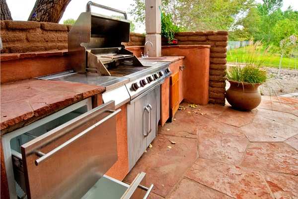Professional outdoor kitchen masonry installation with brick and stone details for a covered patio in Birmingham Alabama