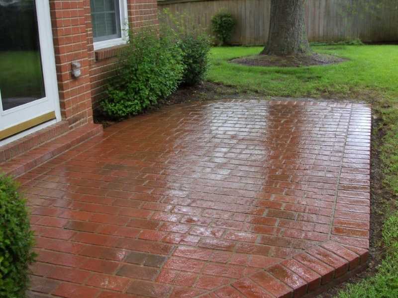 Brick patio below an exterior door threshold for proper drainage in Birmingham, Alabama.