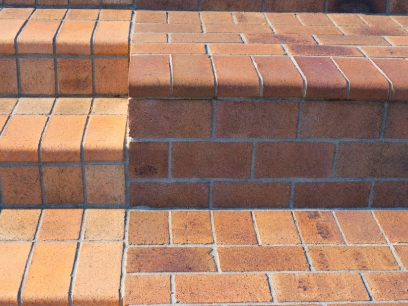 Brick repair on exterior masonry steps in Auburn, Alabama, showing restored brick risers, aligned treads, repaired mortar joints, and even step heights.
