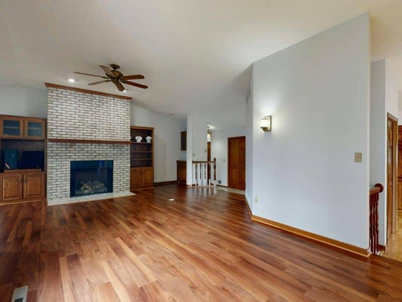 Brick fireplace hearth meeting new flooring with a clean, level transition.
